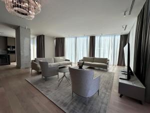 a living room with a couch and a table and chairs at Sea Star Budva in Budva