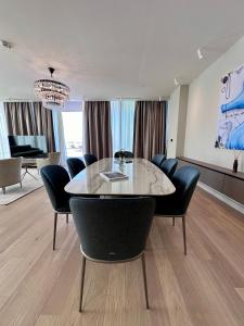 a dining room with a table and chairs at Sea Star Budva in Budva