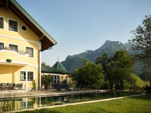 a house with a swimming pool with mountains in the background at Bloberger Hof in Salzburg