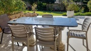 a blue table and chairs on a patio at Hartenbos Tranquility in Mossel Bay