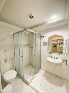 a bathroom with a shower and a toilet and a sink at New Casablanca Praia Hotel in Paulista