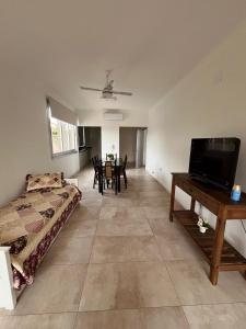 a living room with a bed and a tv and a table at TERRA - Departamento 1 in Esperanza +1 photo