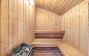 a wooden sauna with a tub in the middle at Holiday Home Råde Strandpark Haderslev Xii in Årøsund