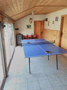a ping pong table in the middle of a room at Кацарила in Gabrovo