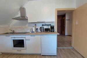 a kitchen with white cabinets and a counter top at WA122 - Große Monteurwohnung Übergangswohnung in Wackersdorf