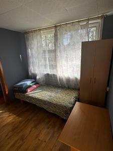 a small room with a couch in front of a window at Vasaras mājiņa pie Rāznas ezera Nr 23 in Ragi +4 photos
