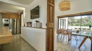 a kitchen and dining room with a glass table at Calma Blanca in Castries