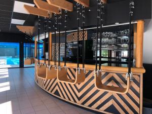 a large wooden boat hanging from a wall in a restaurant at Le Domaine des Pins in Saint-Hilaire-de-Riez
