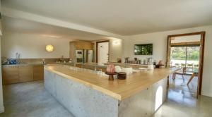 a large kitchen with a large wooden counter top at Calma Blanca in Castries