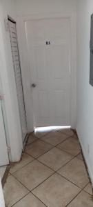 a room with a white door and a tile floor at B1 Best Value on Private Bedroom with Private Bathroom in Little Havana, Miami in Miami