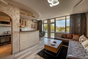 a living room with a couch and a table at Apartments Rosina in Plovdiv