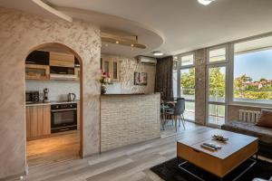 a living room and kitchen with a couch and a table at Apartments Rosina in Plovdiv +70 photos