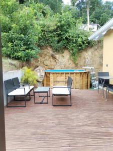 a patio with chairs and a table and a pool at Mankao in Les Trois-Îlets