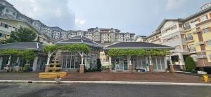 a large building with a fountain in front of it at Apple One Banawa Heights Cebu City Cheap & High Quality in Cebu City