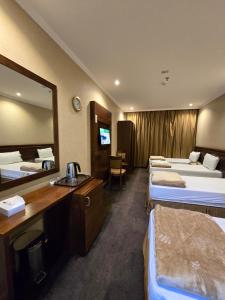 Postel nebo postele na pokoji v ubytování Diouf Al Maqam Hotel 4