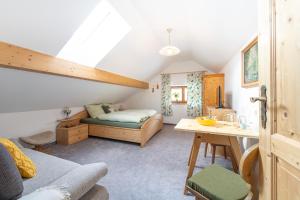 a attic room with a bed and a desk at Appartements K62 in Bad Mitterndorf