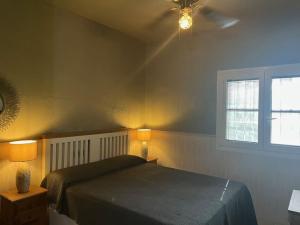 a bedroom with a bed and two lamps and a window at Villa Evelina Puerto Rey Vera in Vera +19 photos