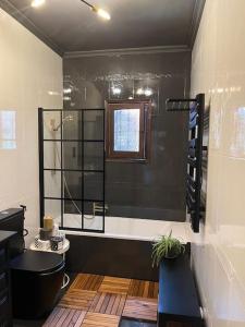 a bathroom with a shower and a black tub at Villa Evelina Puerto Rey Vera in Vera