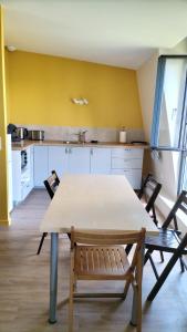 a kitchen with a table and chairs in a room at loft confortable et calme in Arcueil +7 photos