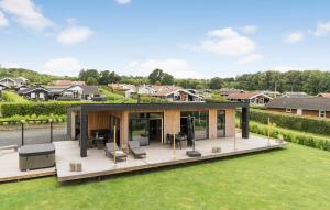 a house with a large deck in a yard at 3 Bedroom Lovely Home In Sjølund in Sjølund