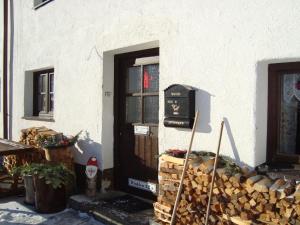 a front door of a house with a pile of wood at Der große Stadl in Oberried
