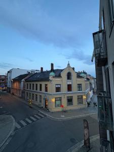 a large white building on a city street at Leilighet i Fredrikstad in Fredrikstad