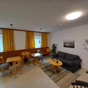 a living room with a couch and a table and chairs at Waldboden in San Leonardo in Passiria