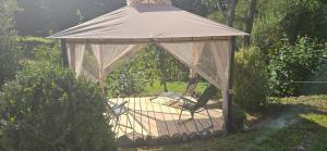 a gazebo with a person standing in it at Wohnmobilstellplatz in Mecklenburg-Vorpommern - ab Juni Dixi WC in Carpin