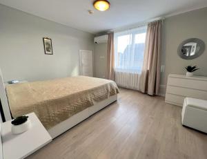 een slaapkamer met een bed en een groot raam bij Vintage 70 Villa in Šiauliai