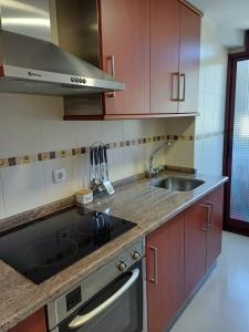 a kitchen with a sink and a stove at Mar de Covelo in Pontevedra