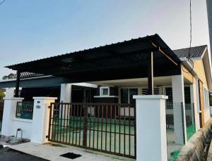 a house with awning over a gate at Homestay Jannah Changlun in Changlun