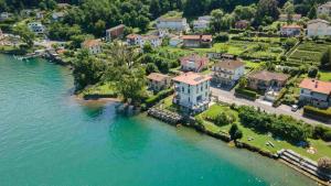 an aerial view of a house on a island in the water at Villa Patria B&B in Brusino Arsizio