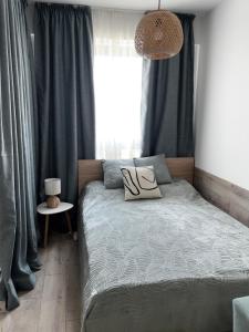 a bedroom with a bed and a large window at Apartment KALINA with free private parking in Plovdiv