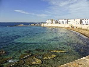 una playa con un grupo de edificios y el agua en Appartamento Mancaversa Centro, 200m mare, en Marina di Mancaversa