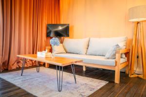 a living room with a couch and a table at Harsa Eco Luxury Camp in Gobleg