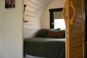 a room with a bed in a tiny house at Ben Nevis Pod in Fort William