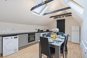 a kitchen and dining room with a table and chairs at Redhill Hideaway Stylish Spacious Apartment in Redhill +12 photos