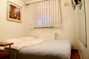 Postel nebo postele na pokoji v ubytování Domin Osijek