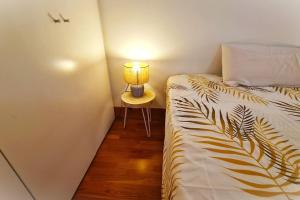 a bedroom with a bed with a lamp on a table at BEACH VALENCIA LUXURY E-Arenas 117 Apartment with terrace in Edificio Arenas in Valencia