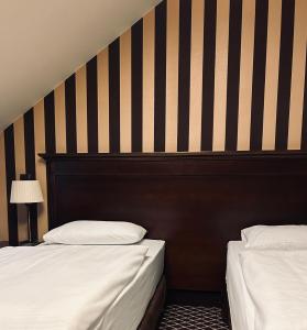 Posteľ alebo postele v izbe v ubytovaní Hotel Wileński