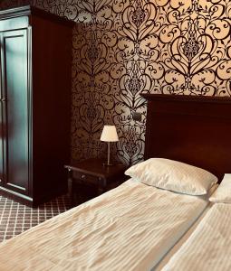 Posteľ alebo postele v izbe v ubytovaní Hotel Wileński