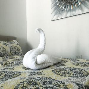 a white swan sitting on top of a bed at Domo Arigato 3 in San Juan +20 photos