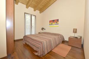 a bedroom with a bed and a dresser and a window at Crotto Letizia in Argegno