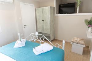 a bedroom with a blue table with towels on it at Pappous Adreas in Skiathos