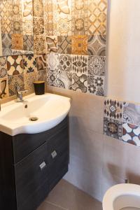 a bathroom with a sink and a toilet at Pappous Adreas in Skiathos +54 photos