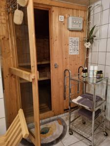 a room with a wooden cabin with a glass table at Ferienhaus Falknerei am Rennsteig in Winterstein