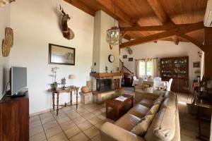 a living room with a couch and a fireplace at La Terrasse in Douzillac