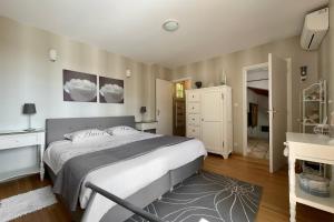 a bedroom with a large bed and a bathroom at La Terrasse in Douzillac +25 photos