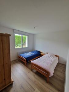 a bedroom with two beds and a window at La désirée in Blangy-sur-Bresle