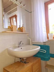 a bathroom with a white sink and a mirror at Ruhige Ferienwohnung in Bad Tölz in Bad Tölz +6 photos